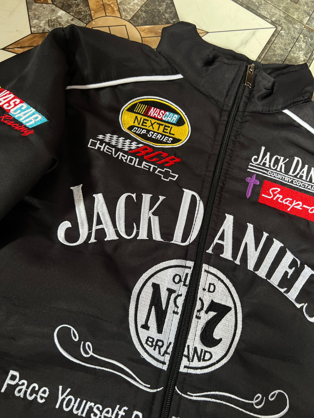 jack daniels f1 jacket, jack daniels racing jacket, jack daniels embroidered jacket, jack daniels moto jacket, black jack daniels jacket, f1 racing jacket india, paper castle jacket, streetwear jacket, oversized streetwear jacket, premium streetwear india, trendy jackets for men, unisex bomber jacket, heavy embroidery jacket, premium quality jacket, biker style jacket, motorsport jacket, formula 1 jacket, racing team jacket, motorsports apparel, f1 fan merchandise, best jackets for men india, affordable rac